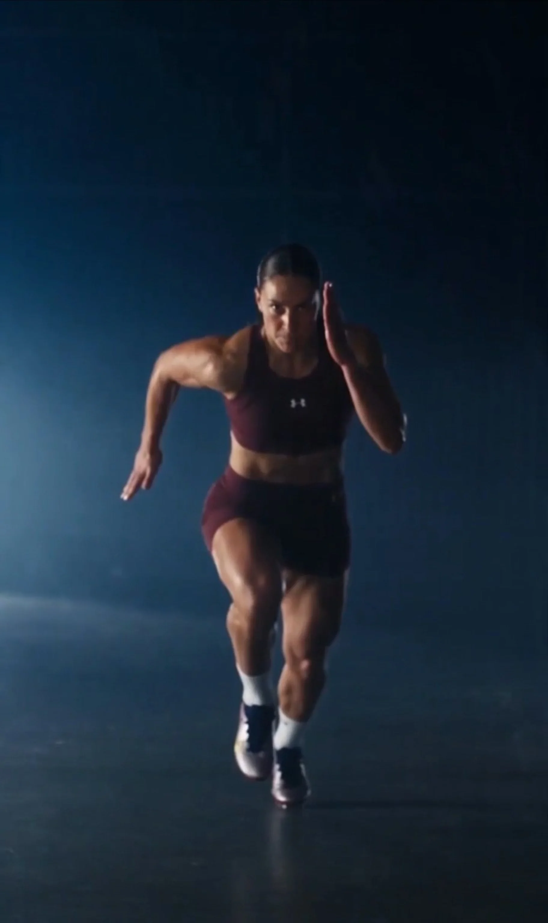 Women's football athlete sprinting during a dramatic training session